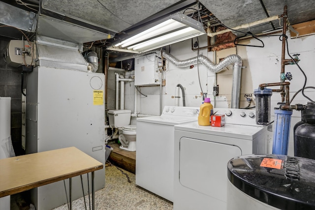 clothes washing area featuring laundry area and washer and clothes dryer