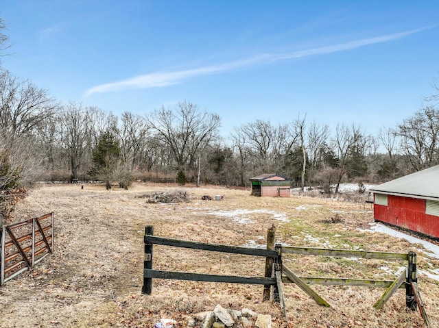 view of yard featuring a rural view and fence