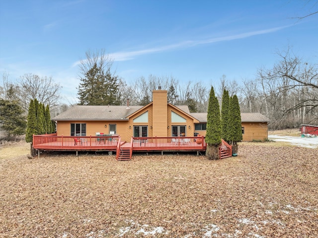 back of property featuring a deck and a chimney