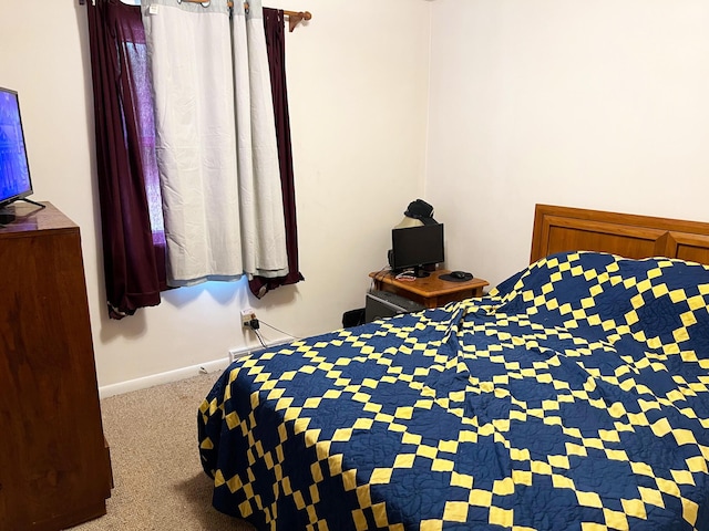 bedroom featuring carpet and baseboards