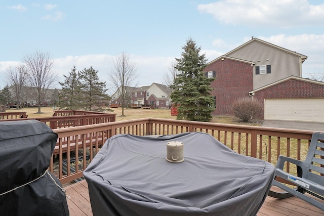 deck featuring a yard and grilling area