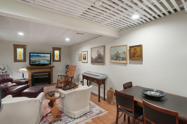 living room featuring light wood finished floors, a fireplace, and recessed lighting