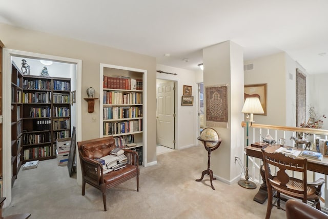 living area featuring built in features, carpet, visible vents, and baseboards