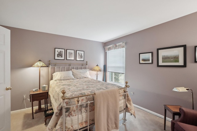 carpeted bedroom featuring baseboards