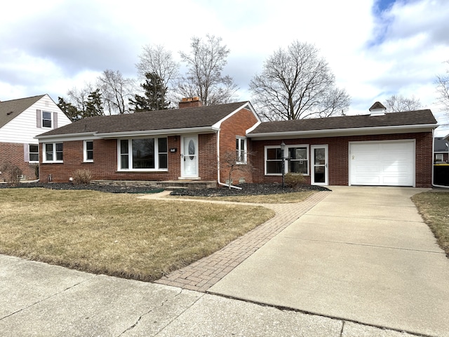 ranch-style home with brick siding, a chimney, concrete driveway, a garage, and a front lawn