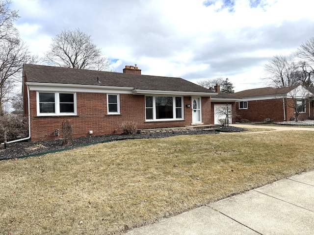 single story home featuring a garage, brick siding, a chimney, and a front lawn