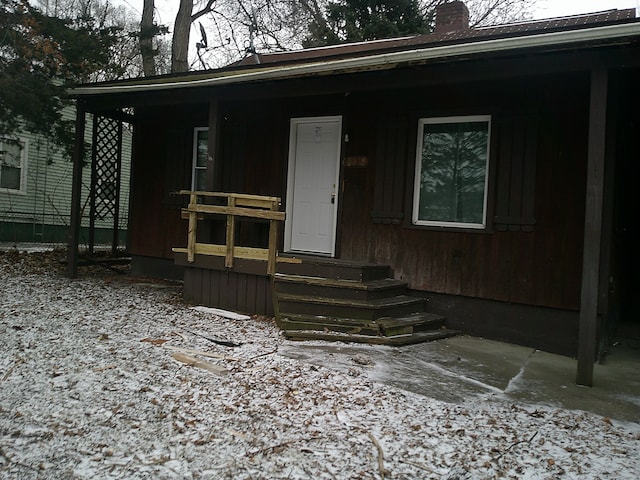 view of front of property featuring covered porch and a chimney