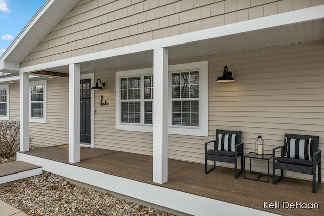 view of exterior entry with a porch