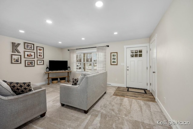 carpeted living room featuring baseboards and recessed lighting