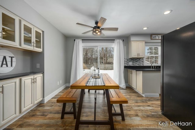 dining space featuring a ceiling fan, recessed lighting, dark wood-style flooring, and baseboards