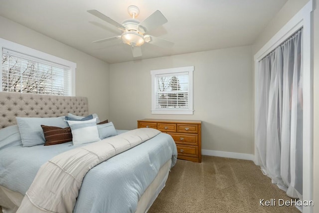 bedroom featuring a ceiling fan, light colored carpet, and baseboards