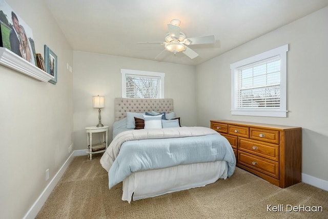 bedroom with ceiling fan, baseboards, and light colored carpet