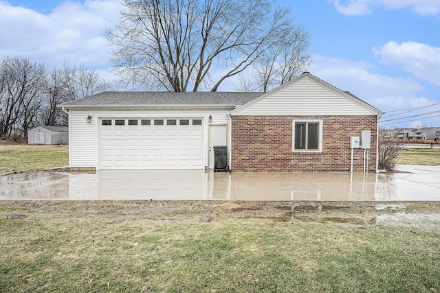 view of side of property with an outbuilding, an attached garage, a storage shed, brick siding, and a lawn