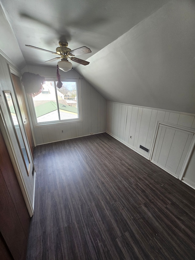 additional living space with vaulted ceiling, ceiling fan, and dark wood-style flooring