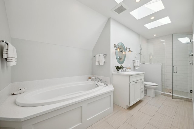 bathroom with vaulted ceiling with skylight, a garden tub, vanity, visible vents, and a shower stall