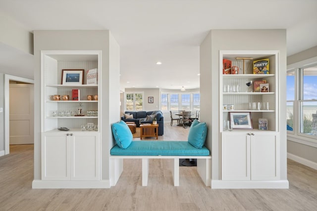 living area featuring light wood-type flooring, baseboards, and recessed lighting