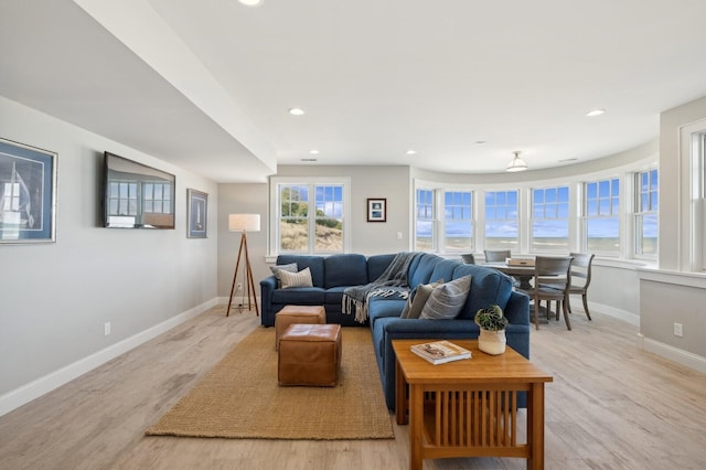 living room with baseboards, recessed lighting, and light wood-style floors