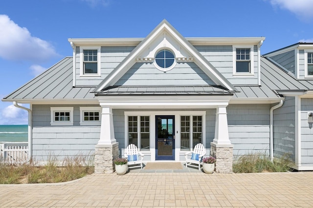 back of house with metal roof, french doors, and a standing seam roof