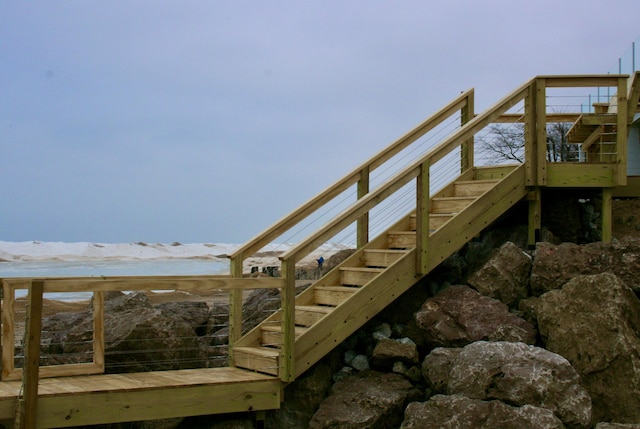view of dock with stairway and a deck