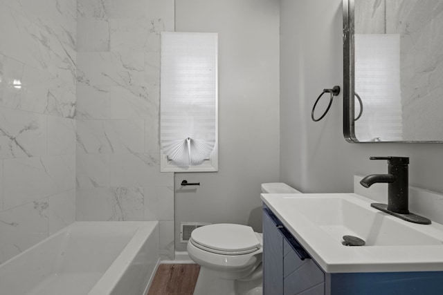 bathroom with visible vents, vanity, toilet, and wood finished floors