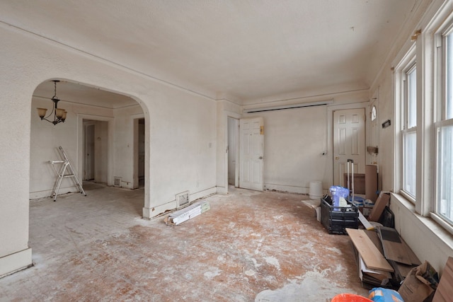 spare room featuring arched walkways