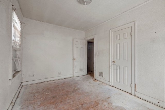 interior space featuring visible vents and crown molding