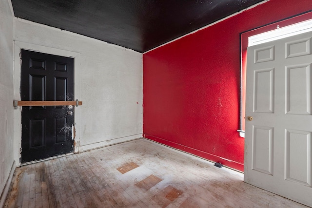 entrance foyer featuring wood-type flooring and a textured wall