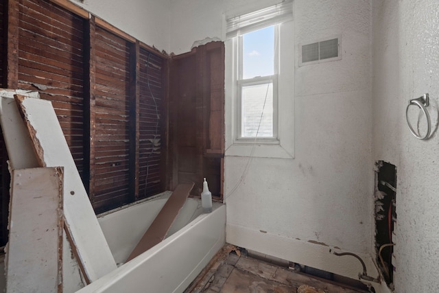 full bathroom with a tub to relax in and visible vents