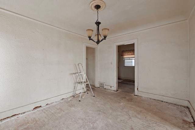 empty room featuring visible vents and an inviting chandelier