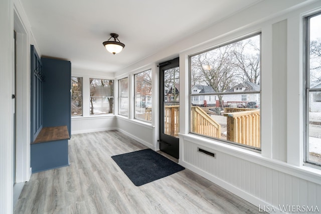 unfurnished sunroom with plenty of natural light