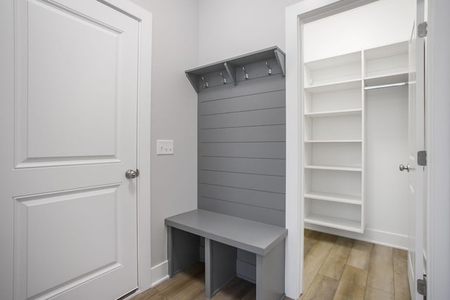 mudroom with baseboards and wood finished floors