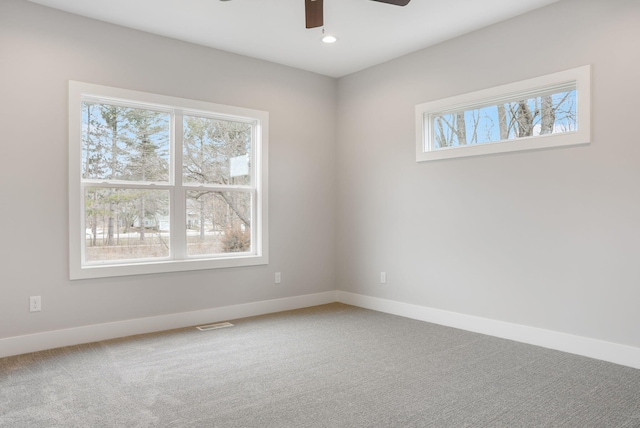 carpeted spare room with visible vents, baseboards, ceiling fan, and recessed lighting