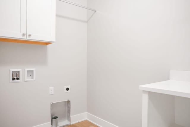 clothes washing area featuring washer hookup, cabinet space, light wood-style flooring, hookup for an electric dryer, and baseboards