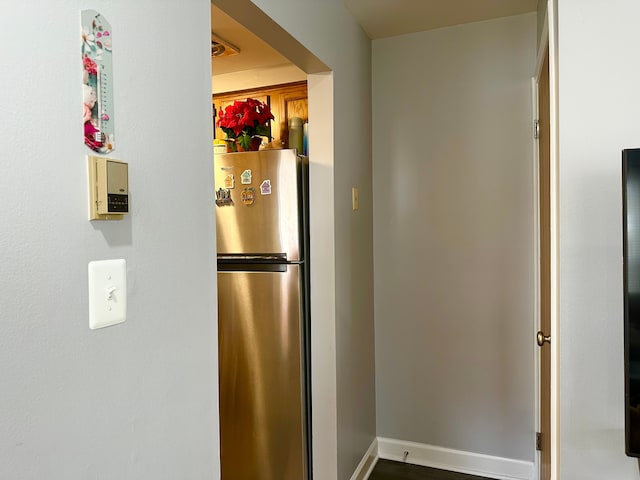 kitchen with freestanding refrigerator and baseboards