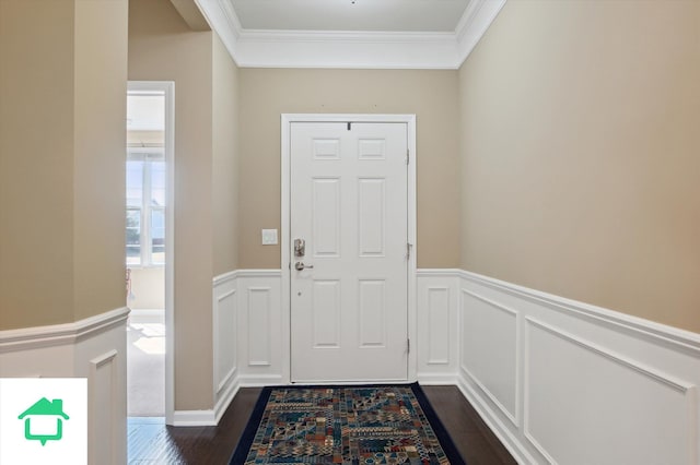 entryway with a decorative wall, dark wood-type flooring, a wainscoted wall, and ornamental molding