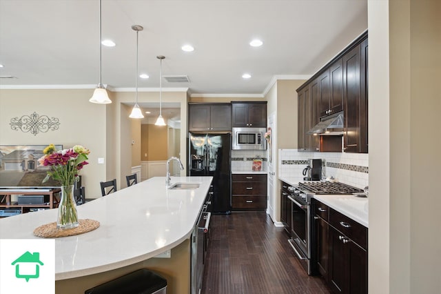 kitchen featuring a sink, stainless steel appliances, dark brown cabinetry, and visible vents