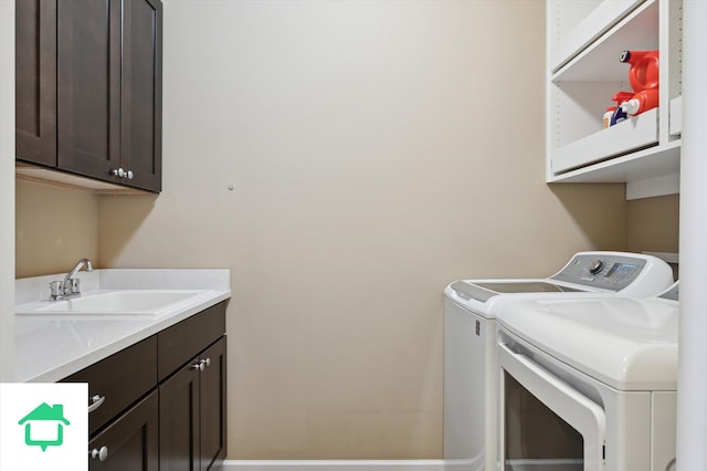 washroom featuring a sink, cabinet space, and washer and clothes dryer