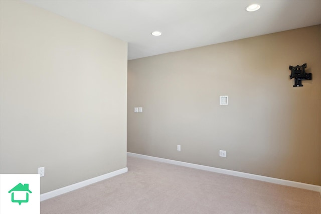 empty room with light carpet, recessed lighting, and baseboards