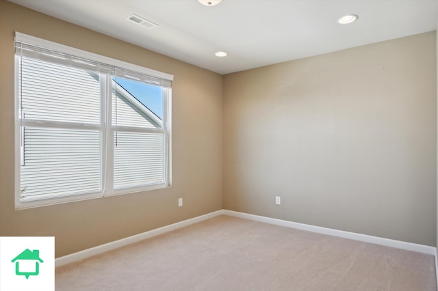 spare room featuring recessed lighting, visible vents, light colored carpet, and baseboards