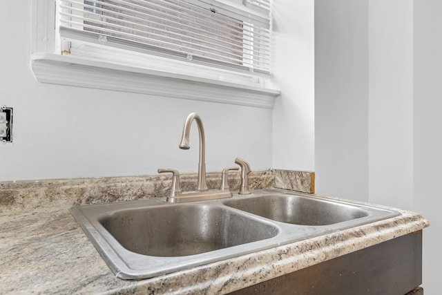 interior details featuring light countertops and a sink