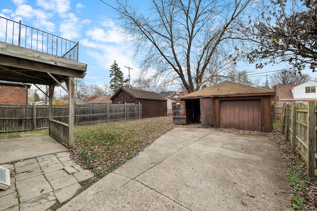 view of yard with an outdoor structure, a fenced backyard, and a patio