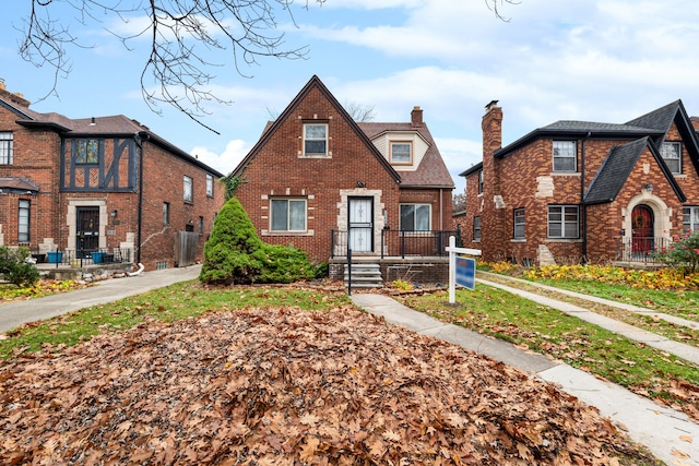 view of front of house featuring brick siding and a chimney