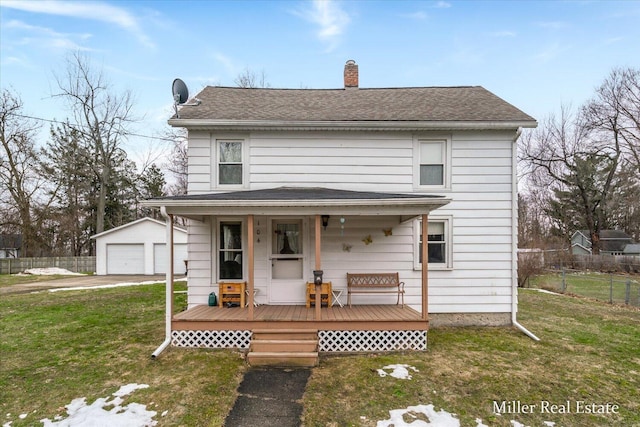 view of front of house with an outbuilding, a detached garage, a chimney, a front yard, and fence