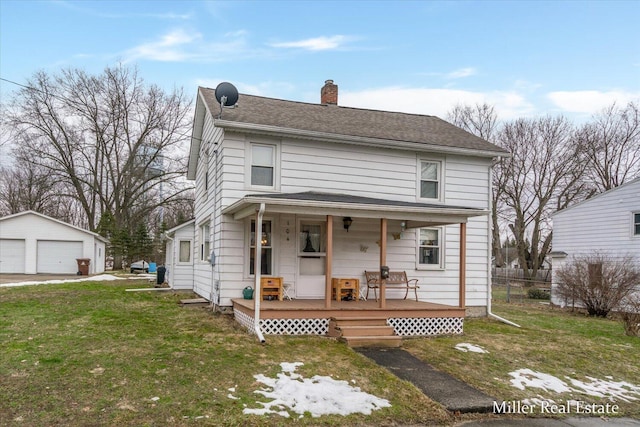 view of front of property with a detached garage, a chimney, covered porch, an outdoor structure, and a front lawn