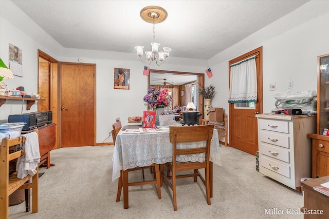 dining area with a chandelier and light carpet