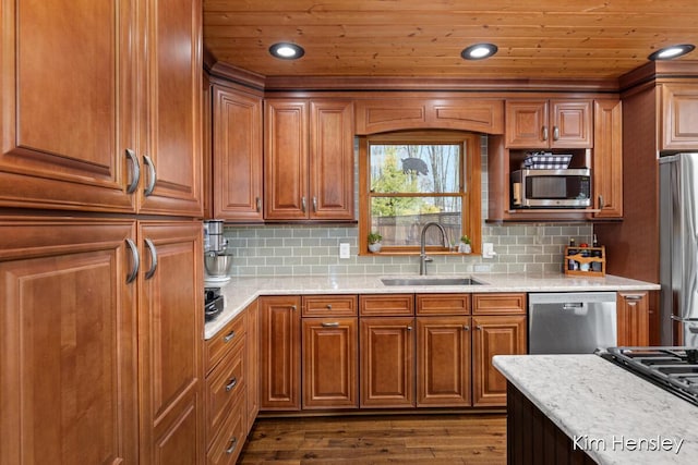 kitchen with tasteful backsplash, dark wood finished floors, wood ceiling, stainless steel appliances, and a sink