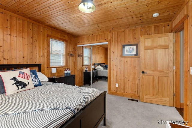 bedroom with light carpet, wood ceiling, visible vents, and a closet