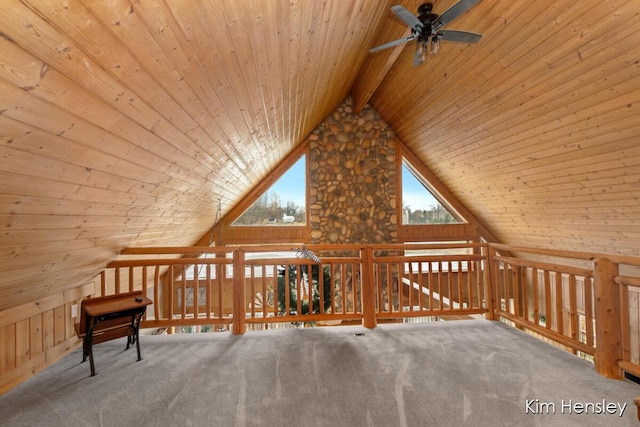 bonus room with lofted ceiling with beams, wooden ceiling, carpet floors, and wood walls