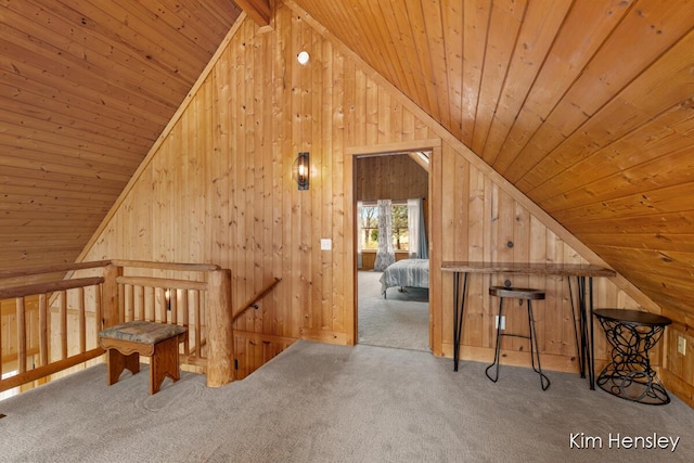 bonus room featuring vaulted ceiling, wooden ceiling, carpet flooring, and wooden walls