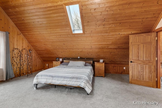 unfurnished bedroom featuring light carpet, lofted ceiling with skylight, wood ceiling, and wooden walls